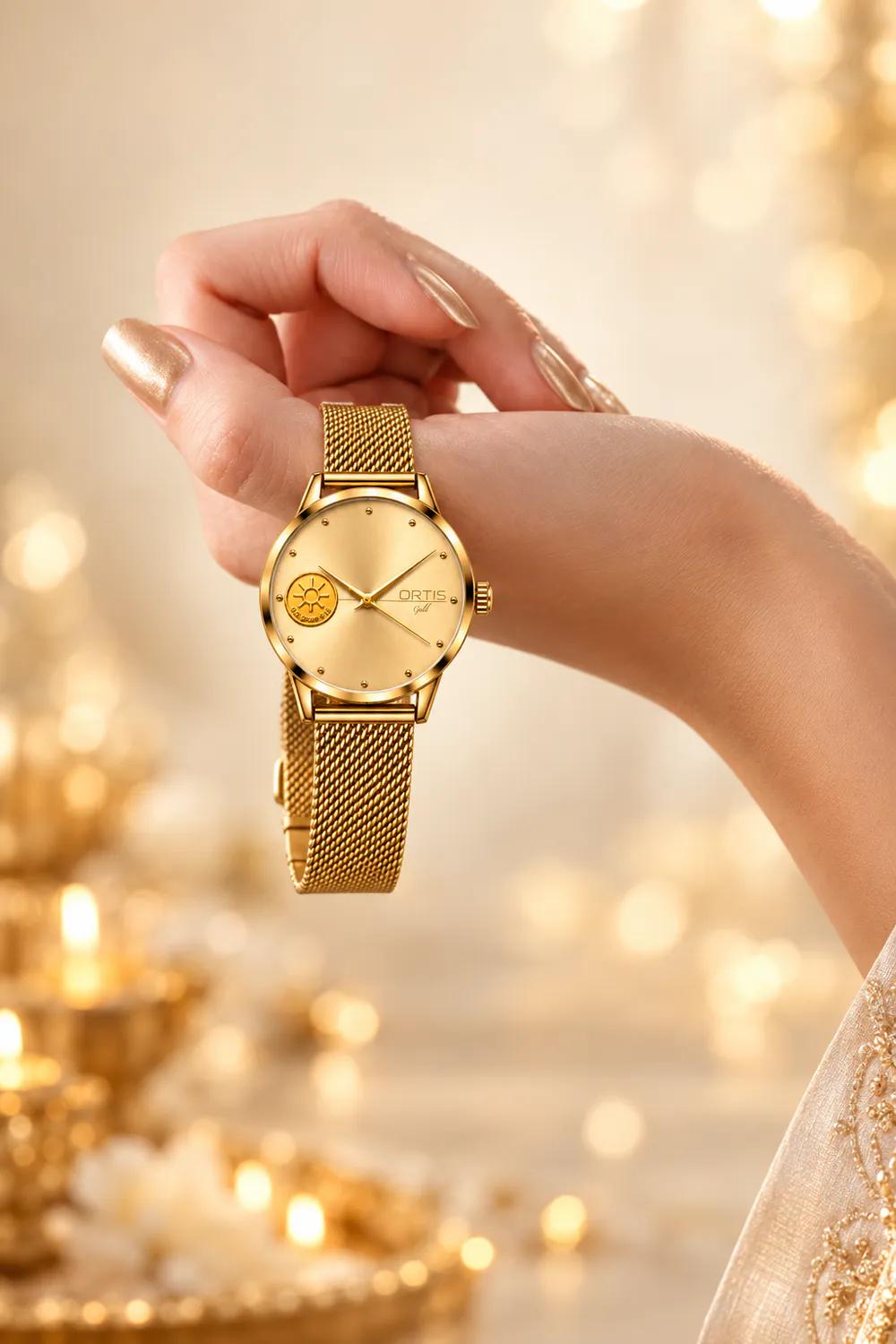 ORTIS women's gold mesh watch with a champagne gold dial worn on the wrist in a festive setting