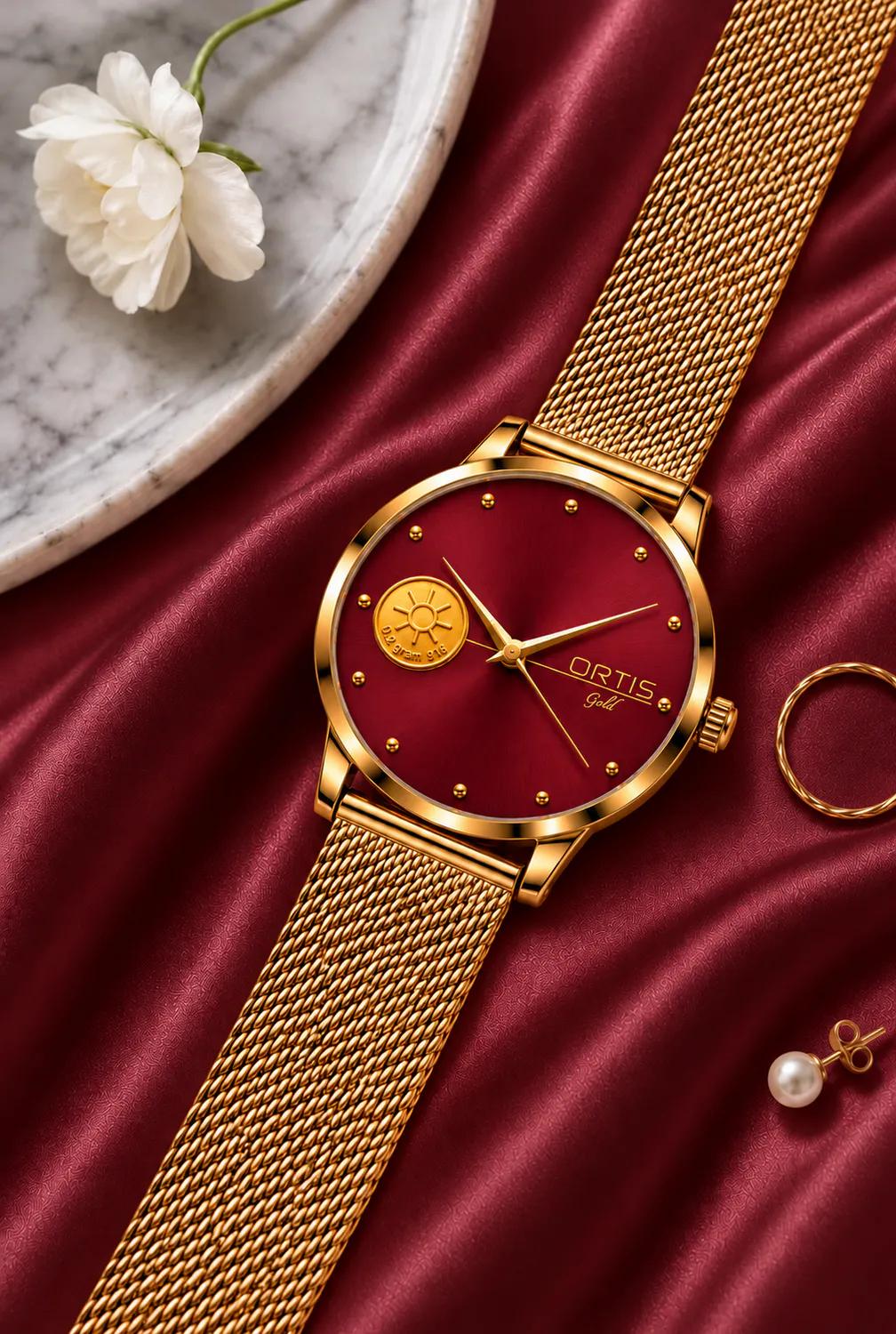 ORTIS women's gold mesh watch with a burgundy red dial laid on red satin